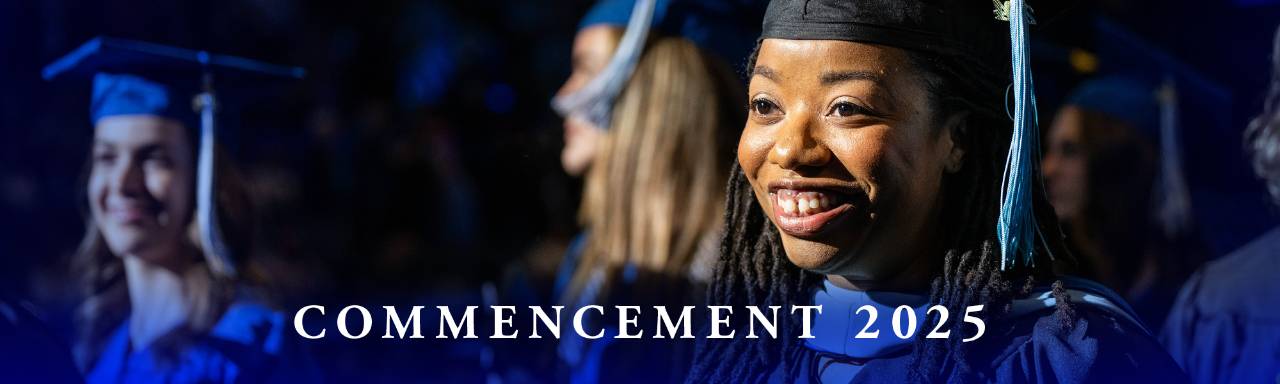 graduate smiling in blue cap and gown - Commencement 2025